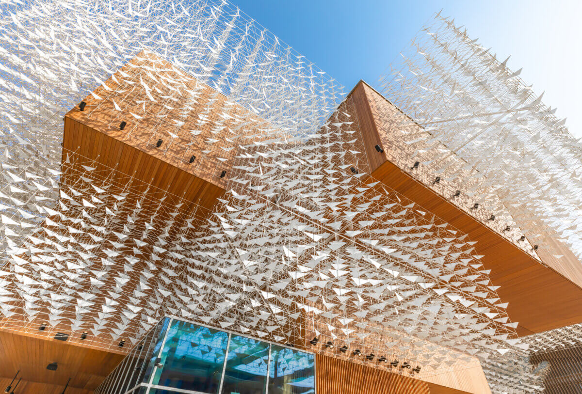 Polish Pavilion at World Expo 2020 outside the pavilion is open, wooden and has a modular structure with flock of birds