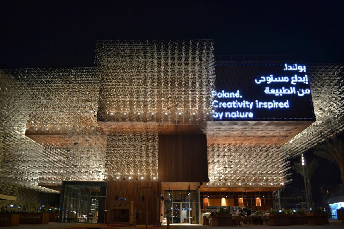 Polish Pavilion at World Expo 2020 outside the pavilion is open, wooden and has a modular structure with flock of birds