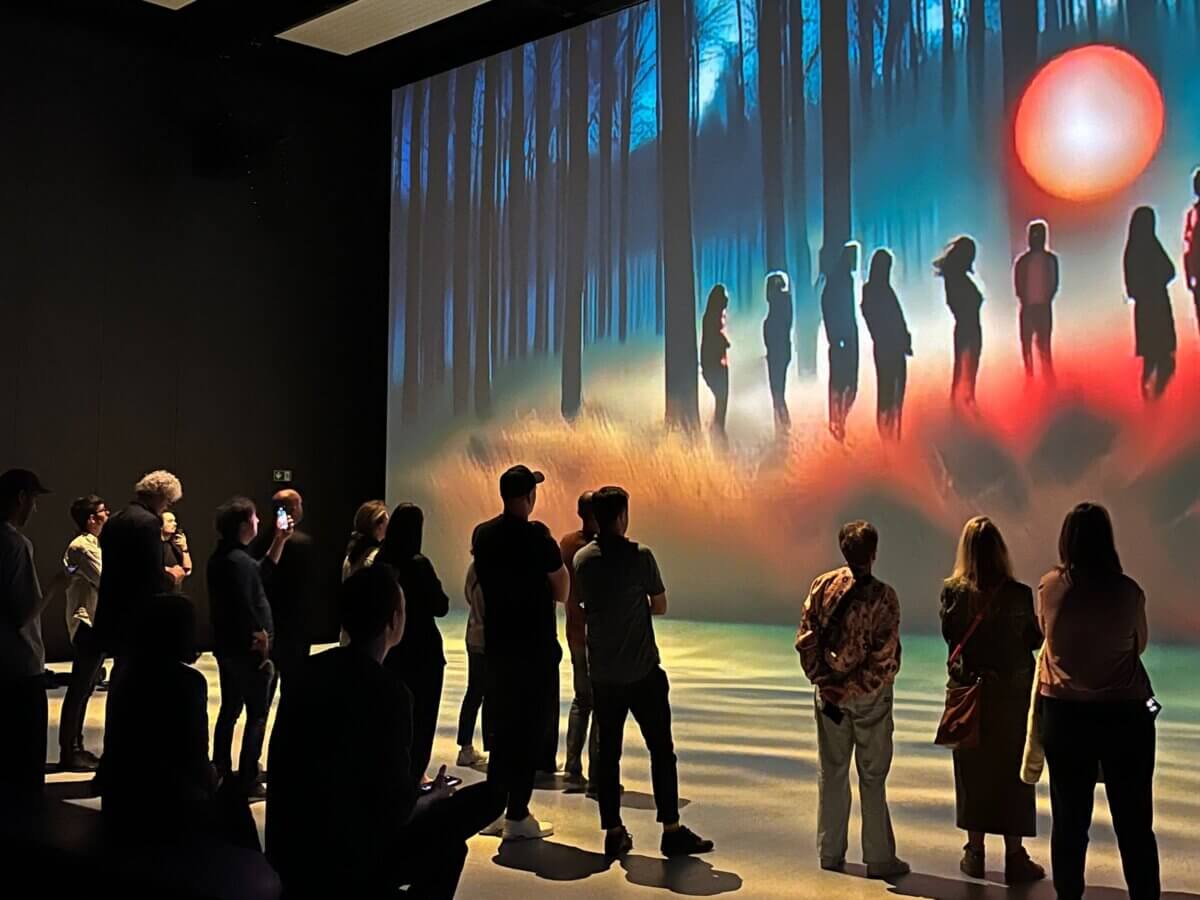 SAM AI Experience at Nxt Museum for Vivendi guests viewing their personal reflections on large immersive screens with storytelling purpose forest and red circle