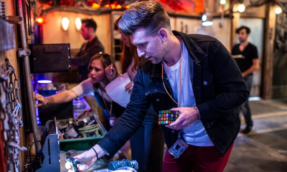 Players engaging in team challenges and puzzles immersive installation