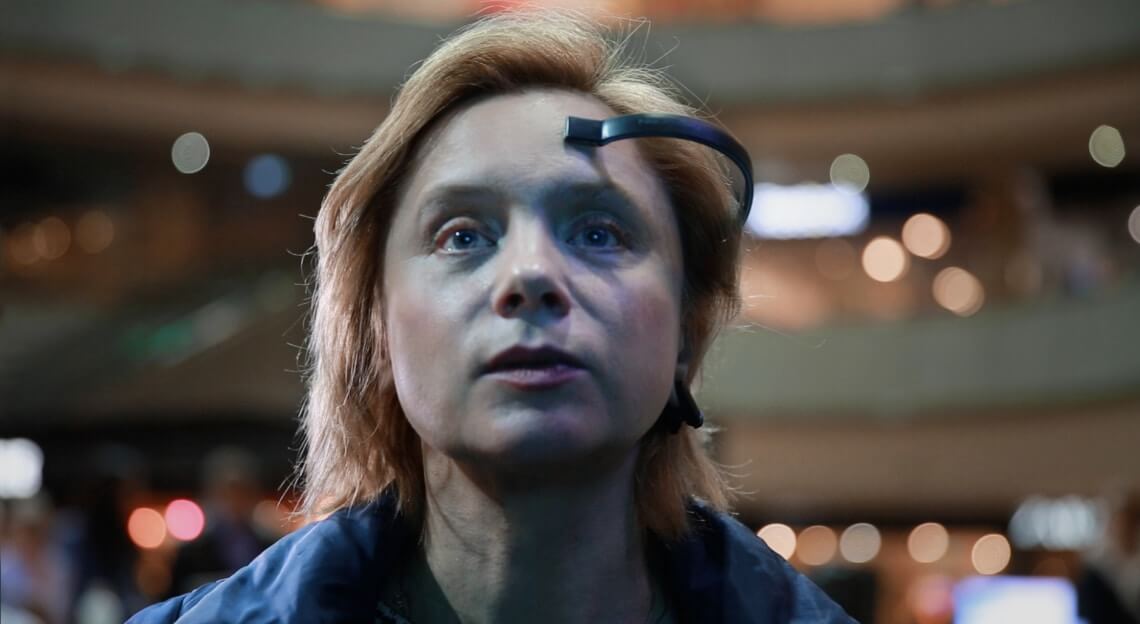 EEG device on participant controlling virtual flight by Tellart