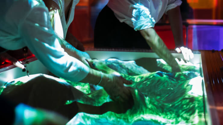 Visitors shaping landscapes with hands in sand